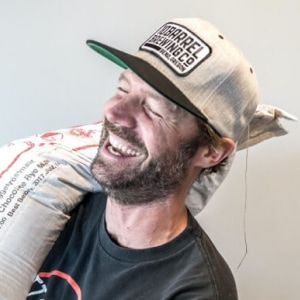 Laughing man carrying sack over his shoulder