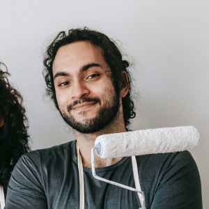 Smiling man holding a paint roller